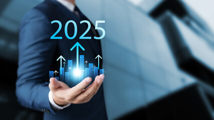 Set business goals for 2025, businessman holds up arrow charging graph Show business growth with...