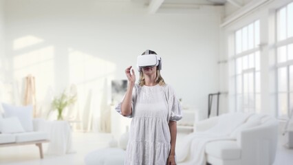 Woman standing in living room using VR glasses turn transfer wonderland metaverse fairytale forest...