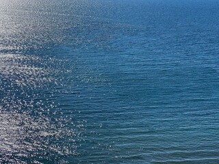 Sea water blue glittering surface.