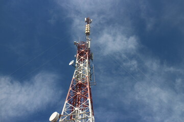Signal tower on blue sky background. Telecommunication tower
