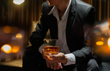businessmen holding a glass of whiskey