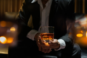 businessmen holding a glass of whiskey