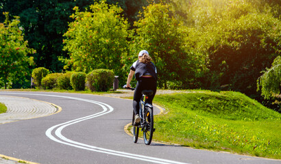Naklejka premium Cyclist ride on the bike path in the city Park 