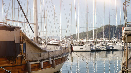 Yachts and boats moor on pier at sunny day. Yacht parking. Luxury marina view