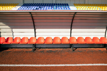 Empty benches of substitute players and coaches on the sidelines of the stadium