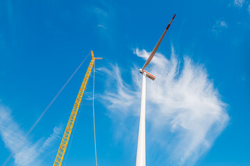 Building and assembling a construction windturbine by Crawler Track Crane - machinery. construction...