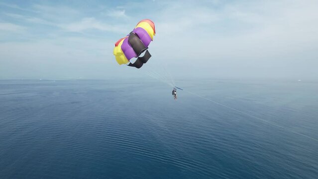 Happy Honeymooner Couple Parasailing in the Maldives, Drone Closeup