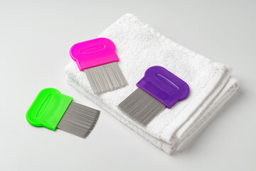 Anti lice combs and towel on white background