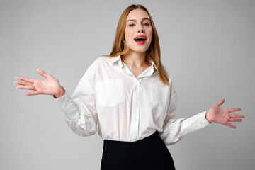 Joyful Young Blonde Woman Smiling against gray background
