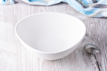 Empty bowl and spoon on wooden table
