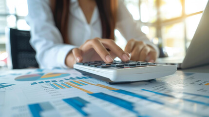 Fototapeta premium Business finance and accounting concept. Businesswoman using calculator to calculate financial report
