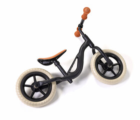 Used modern black balace bike for a small child, isolated