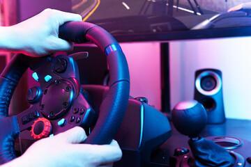 A person is playing a video game with a steering wheel