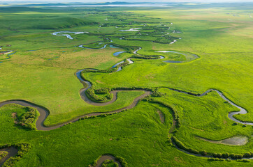 Aerial photography of the nine twists and turns of the Uragai River in the Uragai Grassland in...