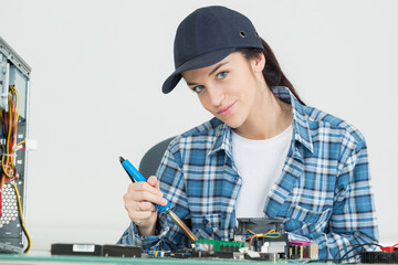 female technician repairing the pc parts