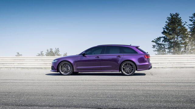 Merlin Purple Audi RS6 on race track. Side profile view of performance version of Audi A6 Avant (C6 generation) in banked corner. Kyiv oblast, Ukraine - April 14 2018.