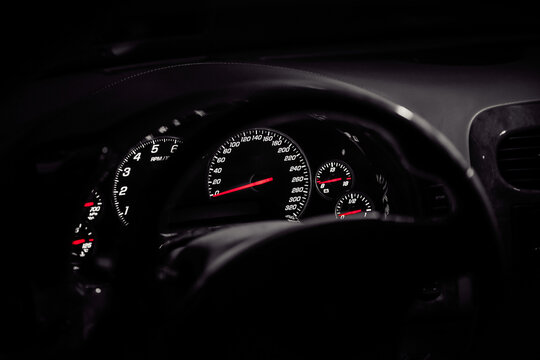 Gauge cluster of C6 Chevrolet Corvette Z06 at night. Dashboard view of Speedtometer and Tachometer(rev counter) of amerian sports car. Kyiv, Ukraine - April 30 2018.