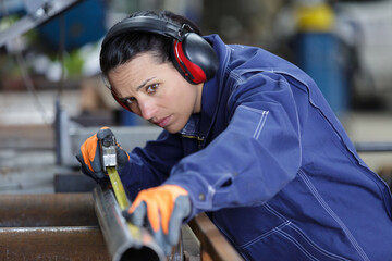 woman worker using measuring tape