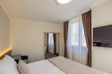 Interior of a luxury hotel double bed bedroom in the morning
