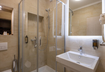 Interior of a hotel bathroom with glass bathroom