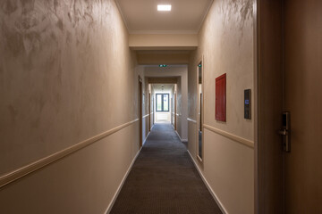 Interior of a carpeted hotel corridor doorway