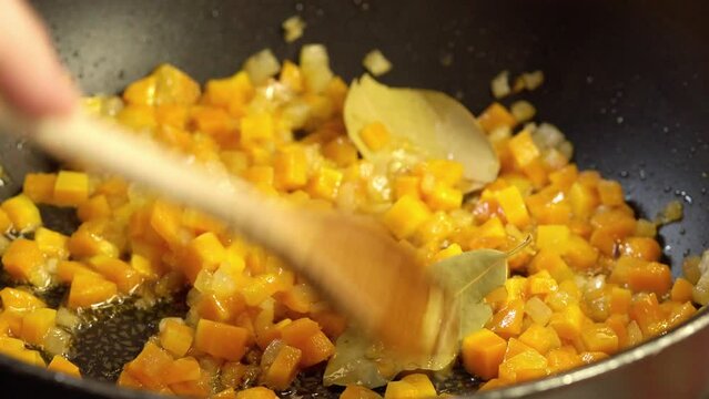 Cooking ground meat with carrots and leeks in sofrito preparation.