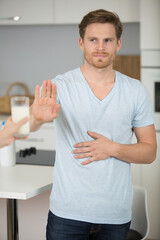 handsome man is making stop gesture with her hand