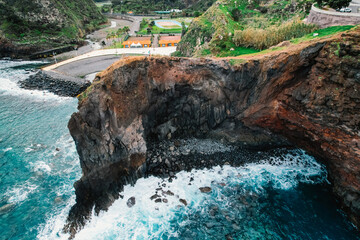 Aerial view of rough ocean with  huge cliff and waves, volcanic beach in Guindaste viewpoint in...