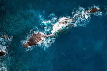 Aerial view of rough ocean with  huge cliff and waves, volcanic beach in Guindaste viewpoint in faial, Madeira, Portugal