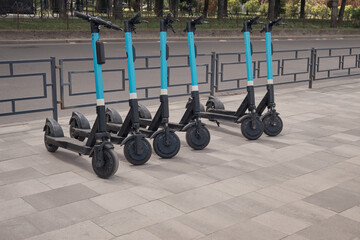 Rental mobile transportation. Electric scooters for public share standing outside in city center