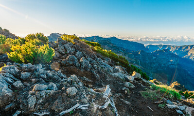 Hiking on the highest peak of Madeira Pico Ruivo next to the cottage Abrigo do Pico Ruivo. Views of...