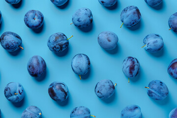 top view of blue plum fruits over blue background