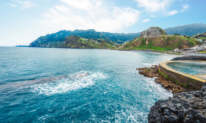Madeira island nature scenery. View of Porto da Cruz village mountains landscape and ocean pool.