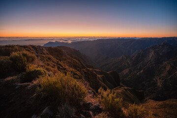 Hiking on the highest peak of Madeira Pico Ruivo next to the cottage Abrigo do Pico Ruivo. Views of...