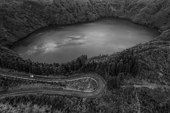 Mountain road switchbacks next to lake, Cete Cidades, Azores