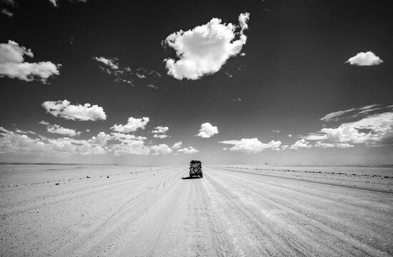 Off road vehicle in the middle of stark, barren desert, Namibia
