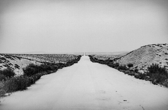 Lonely remote snow covered road through sage, Cisco, Utah