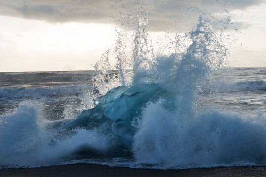 Crashing waves on iceberg strewn beach in southern Iceland