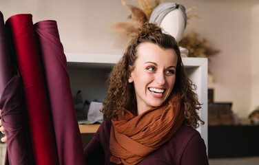 Woman in Curly Hair with a Burst of Laughter in a Stylish Workshop