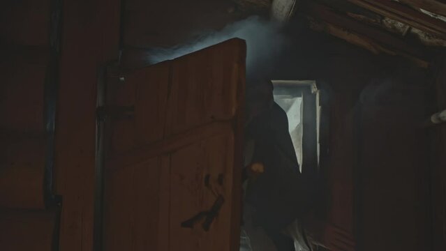 Elders in vintage robes coming inside wooden izba. Media. Men open the wooden beam door and coming inside old house.