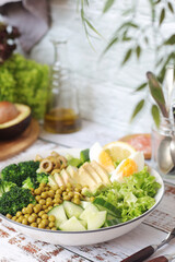 A bowl with a salad made of green vegetables