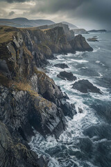 Obraz premium An aerial view of a rocky coastline, with waves crashing against the rugged cliffs, showcasing the contrast between smooth and rough textures. 