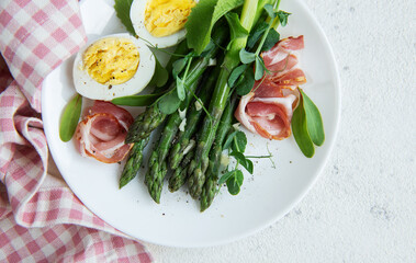 Fresh Asparagus and Prosciutto Salad Served With Boiled Eggs and Microgreens