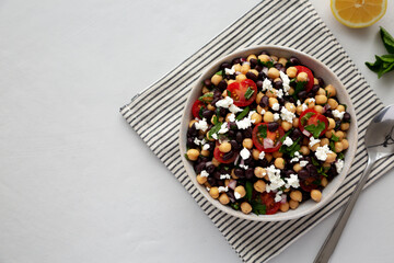 Homemade Chickpea And Black Bean Salad in a Bowl, top view. Copy space.