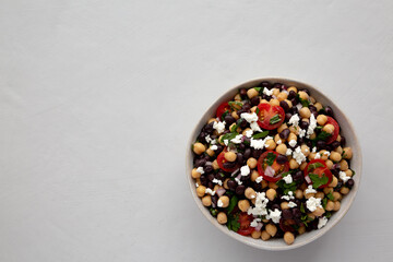 Homemade Chickpea And Black Bean Salad in a Bowl, top view. Copy space.