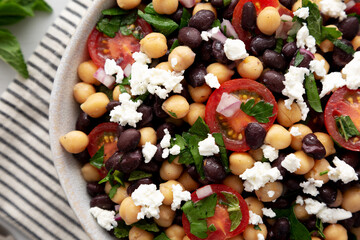 Homemade Chickpea And Black Bean Salad in a Bowl, top view. Close-up.