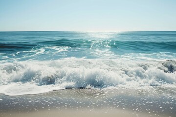 Minimalist coastal scene with gentle waves rolling onto the shore under a clear blue sky, evoking tranquility and natural beauty