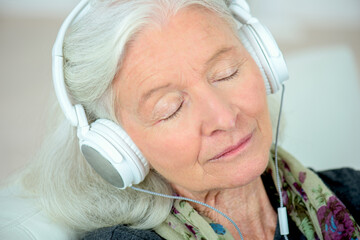a senior woman in headphones