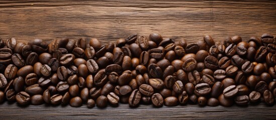 A copy space image featuring coffee beans displayed on a rustic wooden background