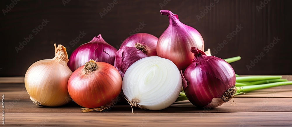 Poster A closeup image of fresh raw onions including red and white onions on a wooden background providing ample copy space for text